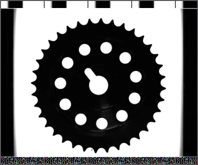 The source blue-backlight capture shows the gear tooth outline, central bore and surrounding holes.