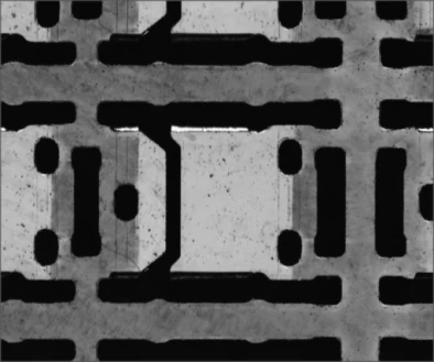 Independent source example B under the white LS-FCS200: substrate paths and openings are visible. These are different samples, not a before-and-after pair.
