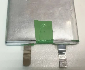 The part: a pouch cell with its two tabs.