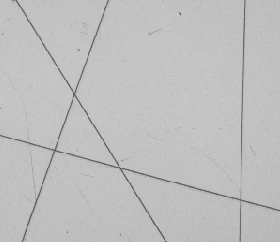 Real white-coaxial capture: several scratch lines are visible in the bright field.