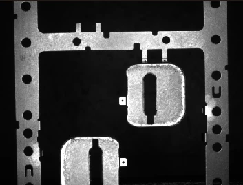 Source white-light capture: stamped faces are bright and openings dark.