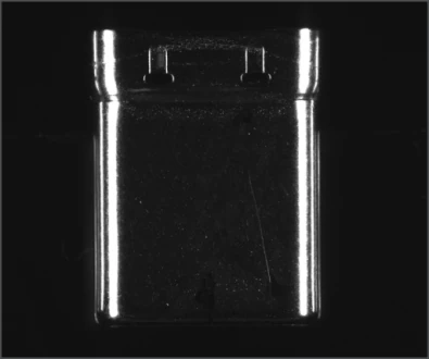 Source example A, labelled surface-scratch inspection: a reflective shell face has bright edges and faint surface lines.