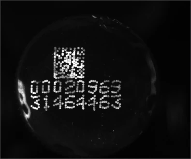 Separate source trial B: a smaller code and printed digits are visible under another UV ring version.