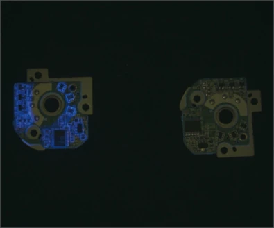 Source board example under a UV bar: blue material contrast is visible on one populated assembly.